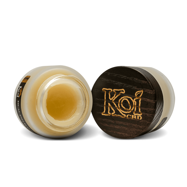 Two jars of Koi Naturals CBD Balm, one opened and the other closed