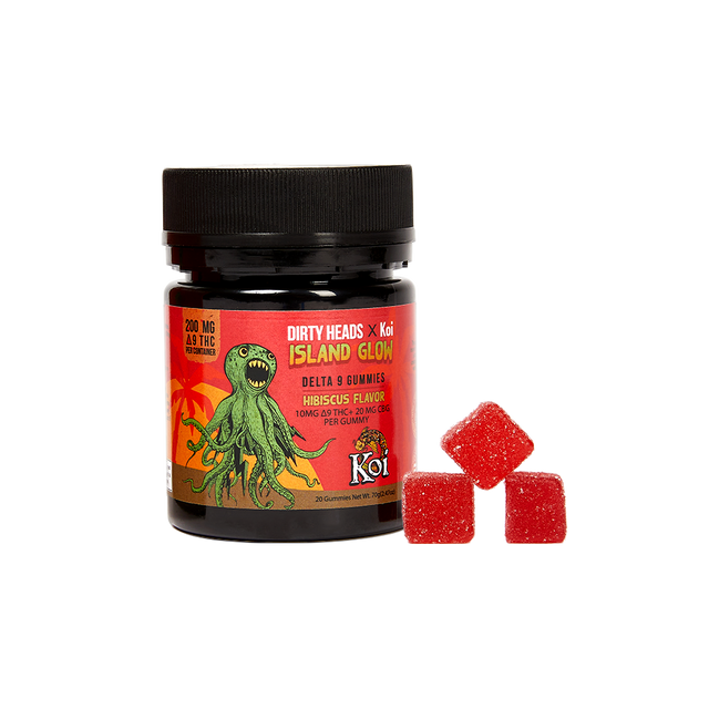 A frontal view of a jar of Dirty Heads x Koi Island Glow hibiscus flavored gummies with 100mg of delta-9 THC and 100mg of CBG and gummies right next to it